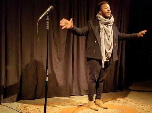 Devon Ginn hosting an open mic at Iconoclast
